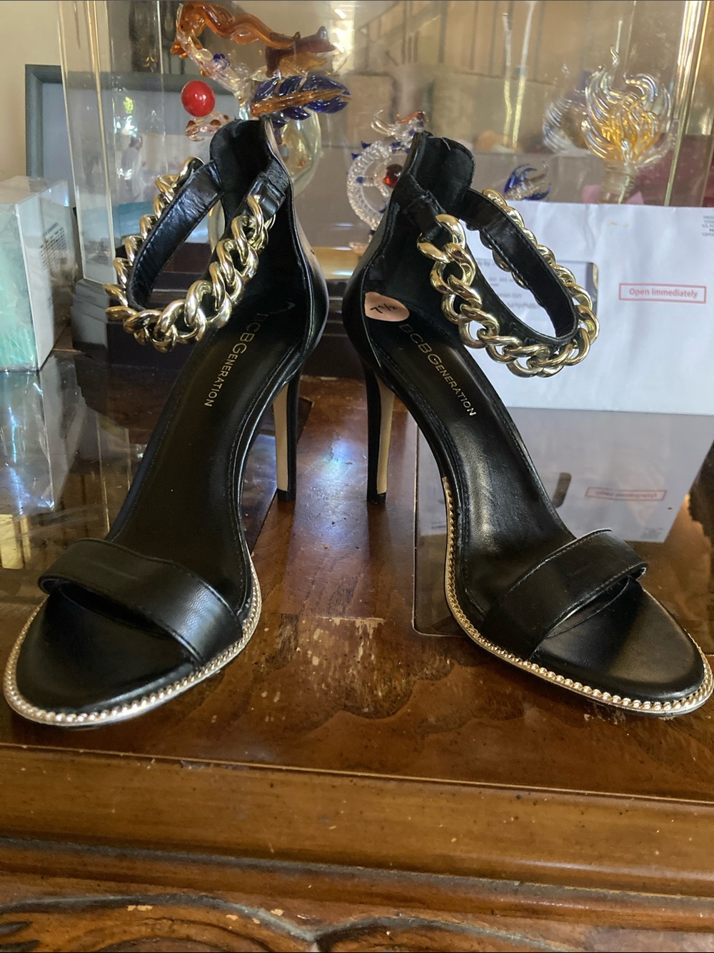 BCBGeneration Black Leather Stiletto Sandals with Gold Chain Ankle